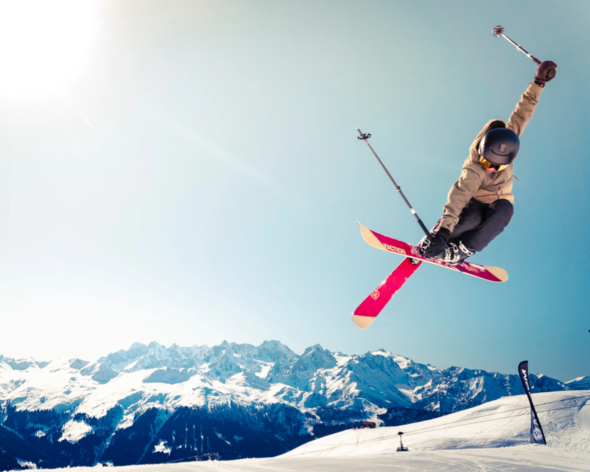 Skier in midair above the mountains