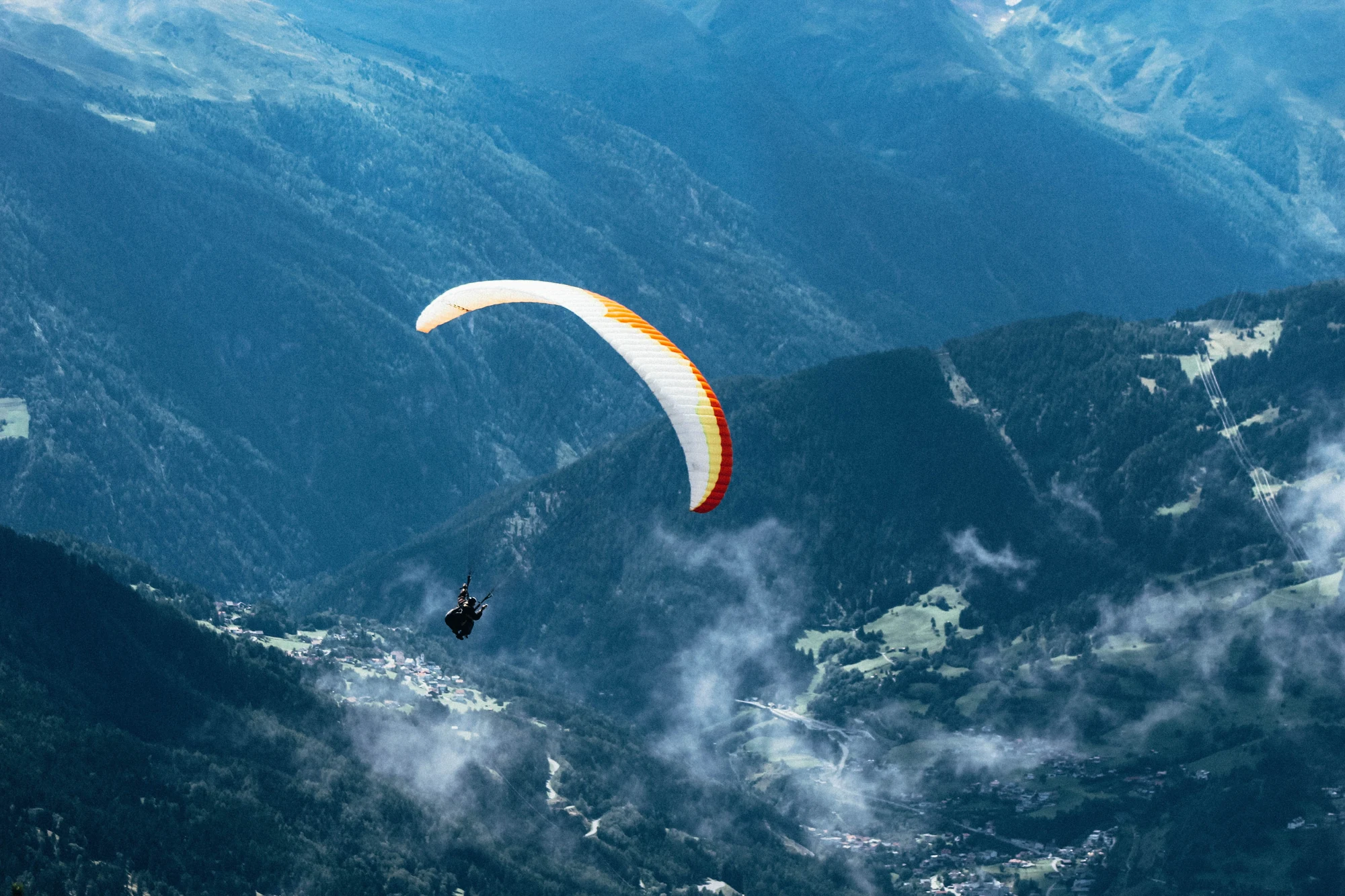 Paraglider above a mountain valley