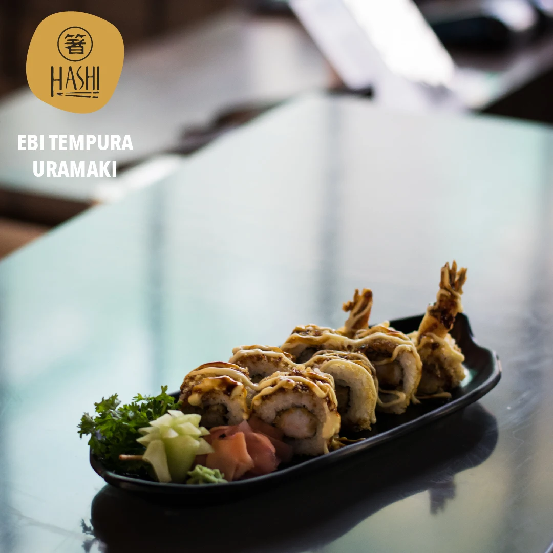 Ebi tempura uramaki on a long black plate